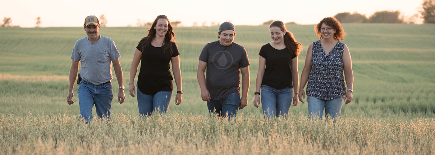 Family walking in grass