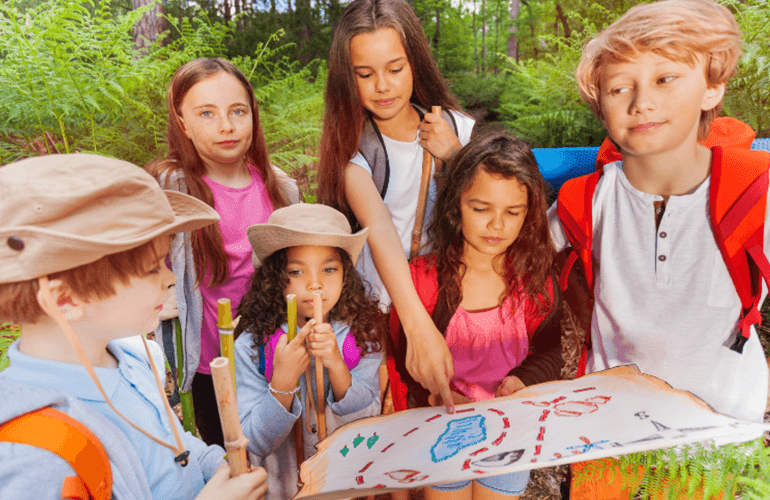 Kids playing treasure hunt in a garden.